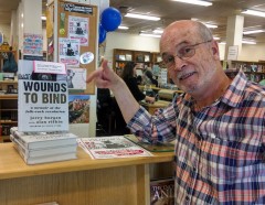 Jerry Burgan with his book, Wounds to Bind: A Memoir of the Folk Rock Revolution