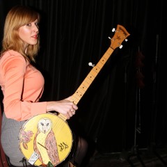 Gayle with the Deering Banjo that she painted. Photo by Dennis Andersen.